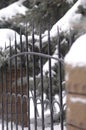 Ancient forged fence made of metal and stone in winter Royalty Free Stock Photo