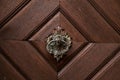 Ancient forged knocker closeup detail on the wooden entrance door. Rothenburg ob der Tauber