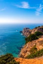 Ancient fort at seaside of Portugal, Nazare. Lighthouse on the rocky cliff. Atlantic ocean coast shoreline. Slopes of promontory