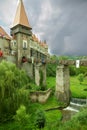 Ancient fortress-castle in Romania against cloudy sky.