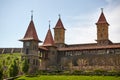 Ancient fortress or medieval castle with a clock on the tower and with weathercocks