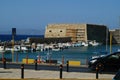 Ancient fortress at the sea port of Agios Nikolaos city, Crete island, Greece at hot summer noon. Royalty Free Stock Photo