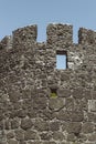 Stone wall of an ancient fortress with a small window. Royalty Free Stock Photo