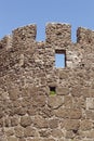 Stone wall of an ancient fortress with windows. Royalty Free Stock Photo