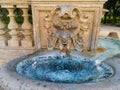 Ancient fountain and bowl with fresh blue water. Rome, Italy.