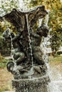 Ancient fountain with sculptures in the garden