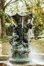 Ancient fountain with sculptures in the garden