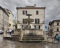 Ancient fountain of the three lions in the Town Hall Square of Assisi, Italy.