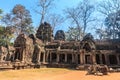 Ancient gallery of amazing Ta Prohm temple overgrown with trees. Mysterious ruins of Ta Prohm nestled among rainforest Royalty Free Stock Photo