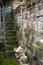 Ancient garden access from stone staircase and natural stone wall with moss and weeds Royalty Free Stock Photo