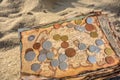 Ancient geographic map with coins lies on the seashore