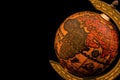 Ancient globe replica with map of Asia, Europe, Africa and Indian Ocean and during the Age of Discovery on black background with Royalty Free Stock Photo