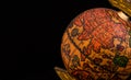 Ancient globe replica with map of East Asia countries on Eastern Hemisphere during the Age of Discovery on black background with Royalty Free Stock Photo