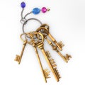 Ancient gold keys on a charm with a chain and precious stones.