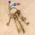 Ancient gold keys on a charm with a chain and precious stones.