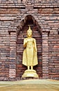 Ancient golden Buddha's staue with brick pogoda