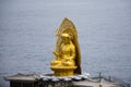 Ancient golden Jijang Bosal statue on stone rock cliffs for korean people travelers travel visit and respect praying blessing wish Royalty Free Stock Photo