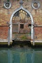 Ancient gothic entrance of a Venetian building with little internal court by a canal, Venice, Italy Royalty Free Stock Photo
