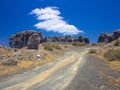 Ancient gravel road through erosion weathering rock formations Plano de El Mojon in the volcanic region of Teguise