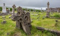 Ancient Graves and Headstones with Bright Green Grass at Ballinskelligs Augustinian Priory in County Kerry, Ireland