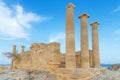 Ancient Greek acropolis. Front view of columns and walls. near the tree grows.