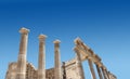 Ancient Greek antique temple facade stone ruins against blue sky