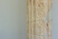 Ancient Greek architecture concept of antique marble column on white wall background texture, copy space Royalty Free Stock Photo