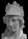 Ancient Greek goddess Athena Pallas statue isolated on black. Marble woman head in helmet sculpture. Royalty Free Stock Photo