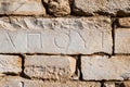 Ancient Greek inscriptions on stone in archeological ruin in ancient Greece site Royalty Free Stock Photo