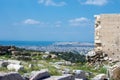 Ancient Greek ruins, ruins amidst lush green grass. Acropolis, Athens, Greece.eautiful view of the capital of Greece - Athens