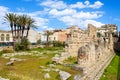 Ancient Greek ruins of the Temple of Apollo in Ortigia Island, Syracuse, Sicily, Italy photographed with adjacent palm trees. Royalty Free Stock Photo