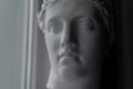 Ancient greek sculpture white plaster copy head of diana in light of window