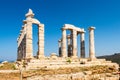 The ancient Greek Temple of Poseidon at Cape Sounion, doric columns and ruins on the hill with crystal blue sky background. Royalty Free Stock Photo