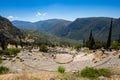 The ancient greek theater of Delphi and the Apollo temple in the archaeological site in Delphi, Fokida, Greece Royalty Free Stock Photo