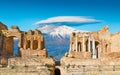 Ancient Greek theatre in Taormina on background of Etna Volcano, Italy Royalty Free Stock Photo