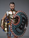 Ancient greek warlord holding shield and plumed helmet