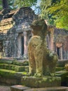 Ancient guardian lion statue at Ta Prohm temple ruins, located in Angkor Wat complex, near Siem Reap, Cambodia.