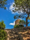 Ancient half-ruined watchtower on blue sky background