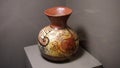 Ancient hand made tall clay vessel decorated