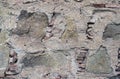 Ancient handcrafted stone wall. The multi-colored exposed stone, brick and mineral layer. Stone pattern, geological texture.