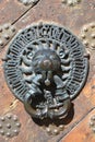 Ancient handle of door with metal lion head. Royalty Free Stock Photo