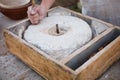 The ancient handmill or quern stone, grinds the grain into flour. Old handmade grinding stones Royalty Free Stock Photo