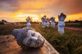 Ancient Head Buddha statue at sunset Royalty Free Stock Photo