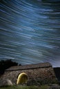 ancient hermitage under star trails sky at night Royalty Free Stock Photo