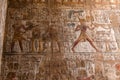 Ancient hieroglyphs and relief engravings carved into a stone wall at Luxor Temple of Amun-Ra