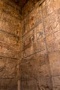 Ancient hieroglyphs and relief engravings carved into a stone wall at Luxor Temple of Amun-Ra