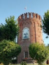 Ancient historic tower with flag in Italy
