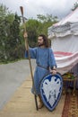 Ancient historical arab warrior with a shield and a spear near the white marquee. festival Vremena i
