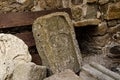 Ancient, historical, archaeological plate, stone with a carved Maltese cross at the wall of an old fortress. Royalty Free Stock Photo