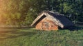 An ancient historical house in the Ukrainian village. A wooden building with roof made of straw Royalty Free Stock Photo